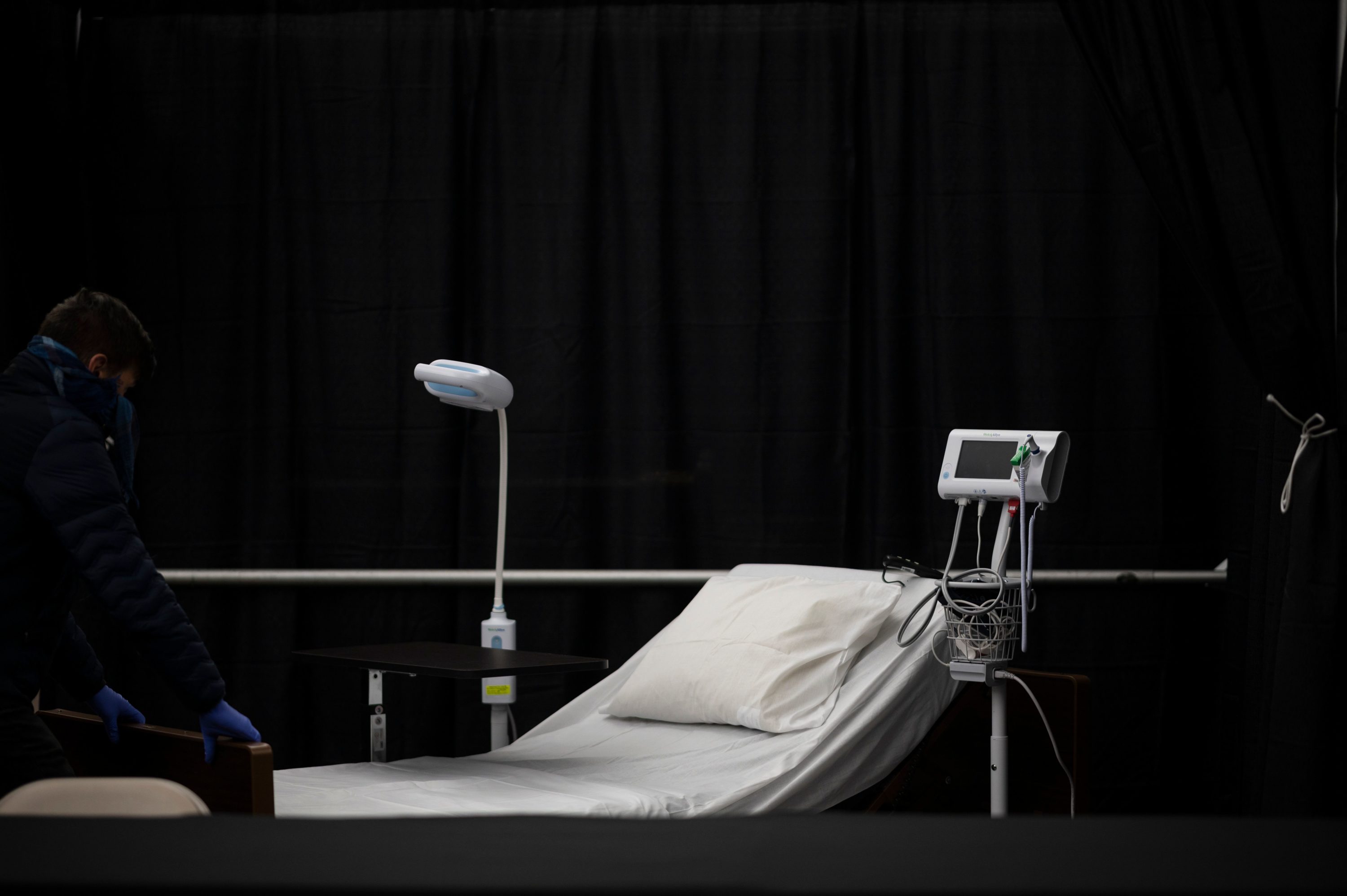 caption: A bed is seen in the temporary hospital located at the USTA Billie Jean King National Tennis Center during the outbreak of the novel coronavirus. (JOHANNES EISELE/AFP via Getty Images)
