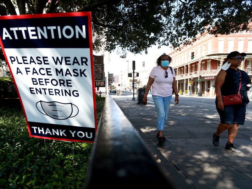 caption: Scientists estimate that near-universal mask use could make a major difference in bringing down coronavirus infections in the United States.