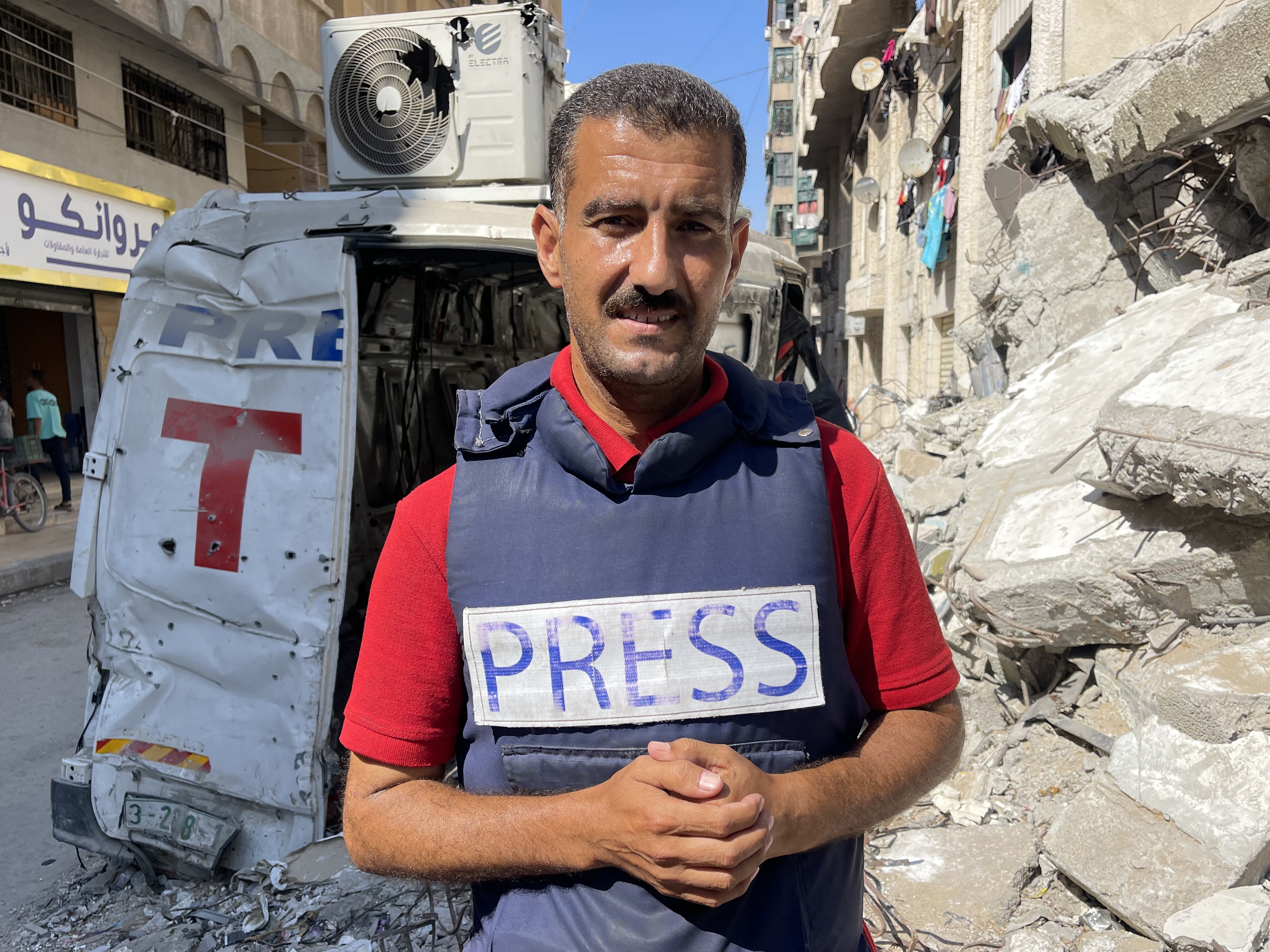 caption: AFP journalist Khader Zaanoun poses for a picture in Gaza City on Tuesday. AFP journalists in the Gaza Strip say chronic food shortages are affecting their ability to cover Israel's conflict with Hamas militants.