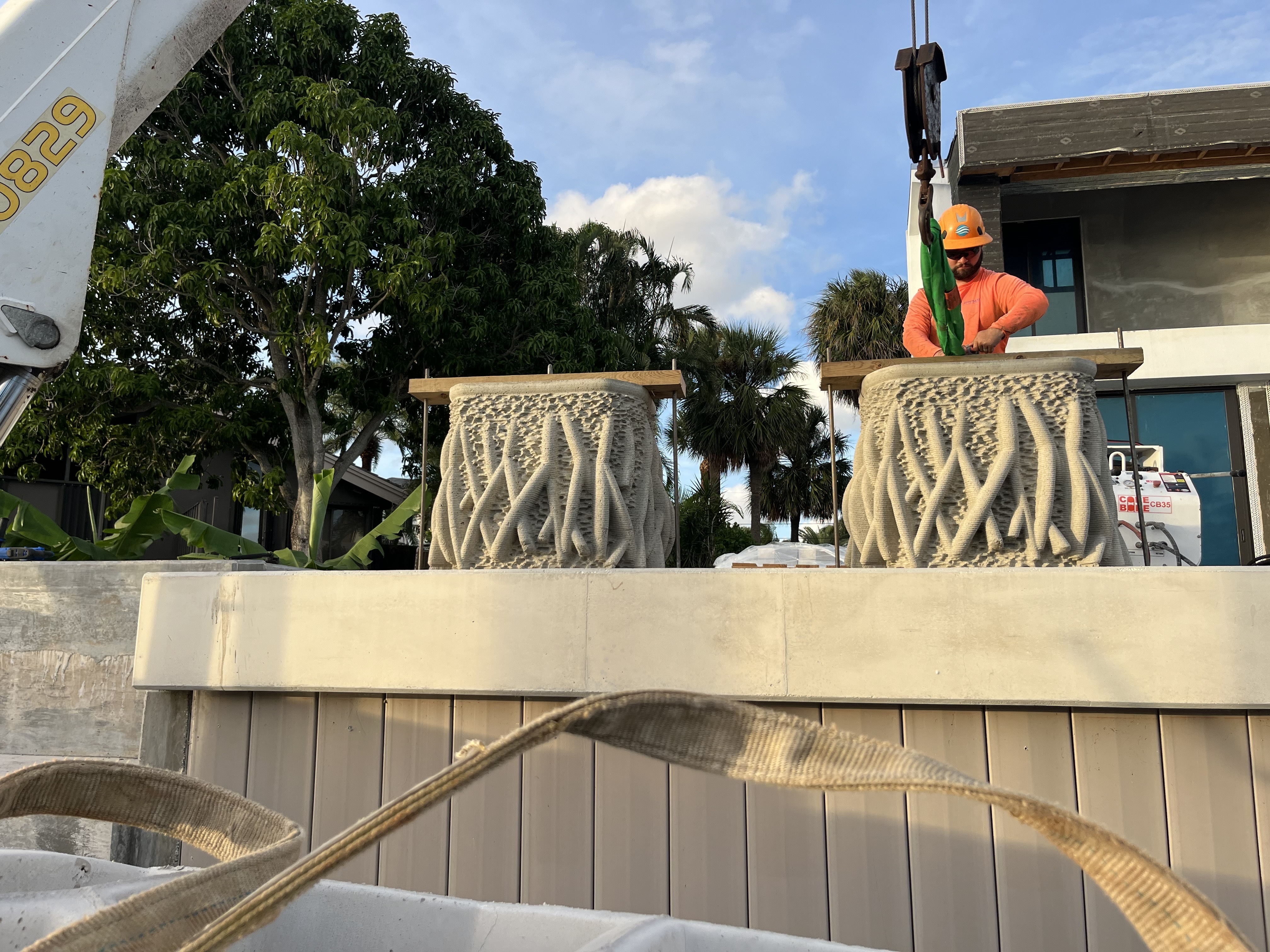 caption: An experiment in nature-inspired design is underway in a South Florida residential canal. Two mangrove planters are being installed on a new seawall to provide habitat for marine wildlife.