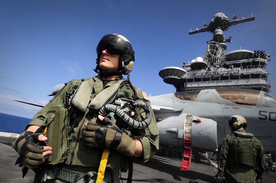 caption: Lt. Roy Walker, from the Electronic Attack Squadron (VAQ) on the flight deck of the aircraft carrier USS John C. Stennis.