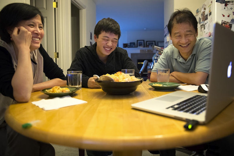 caption: The author (middle) with his mother, Guoping Ma (left), and his father, Siyuan Liu. Here they Skype over dinner with family in Tianjin, China.
