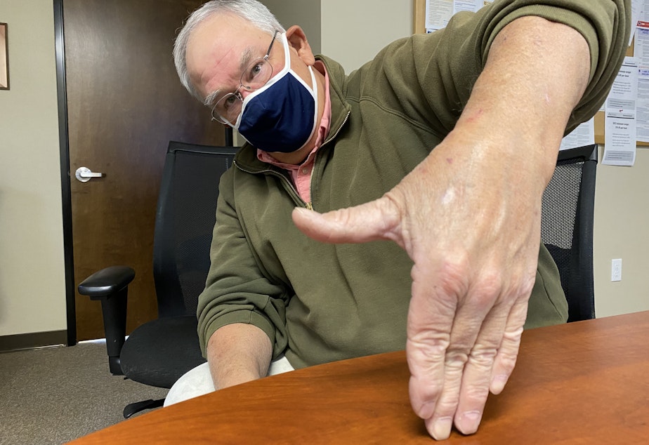 caption: Wheat rancher Chris Herron uses an old method to measure how deep his seed is being planted in his dryland furrows. Up to his thumb in soil -- that’s OK. But if he sinks up to his wrist, he has to adjust the depth at which he’s planting.