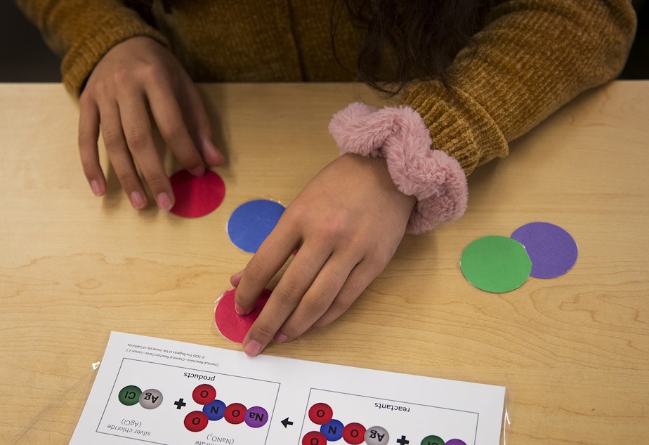 caption: McKinley Bell, a 7th-grade student in Janet Bautista's science class, rearranges atoms while learning about chemical reactions on Thursday, March 28, 2019, at Asa Mercer Middle School in Seattle. 