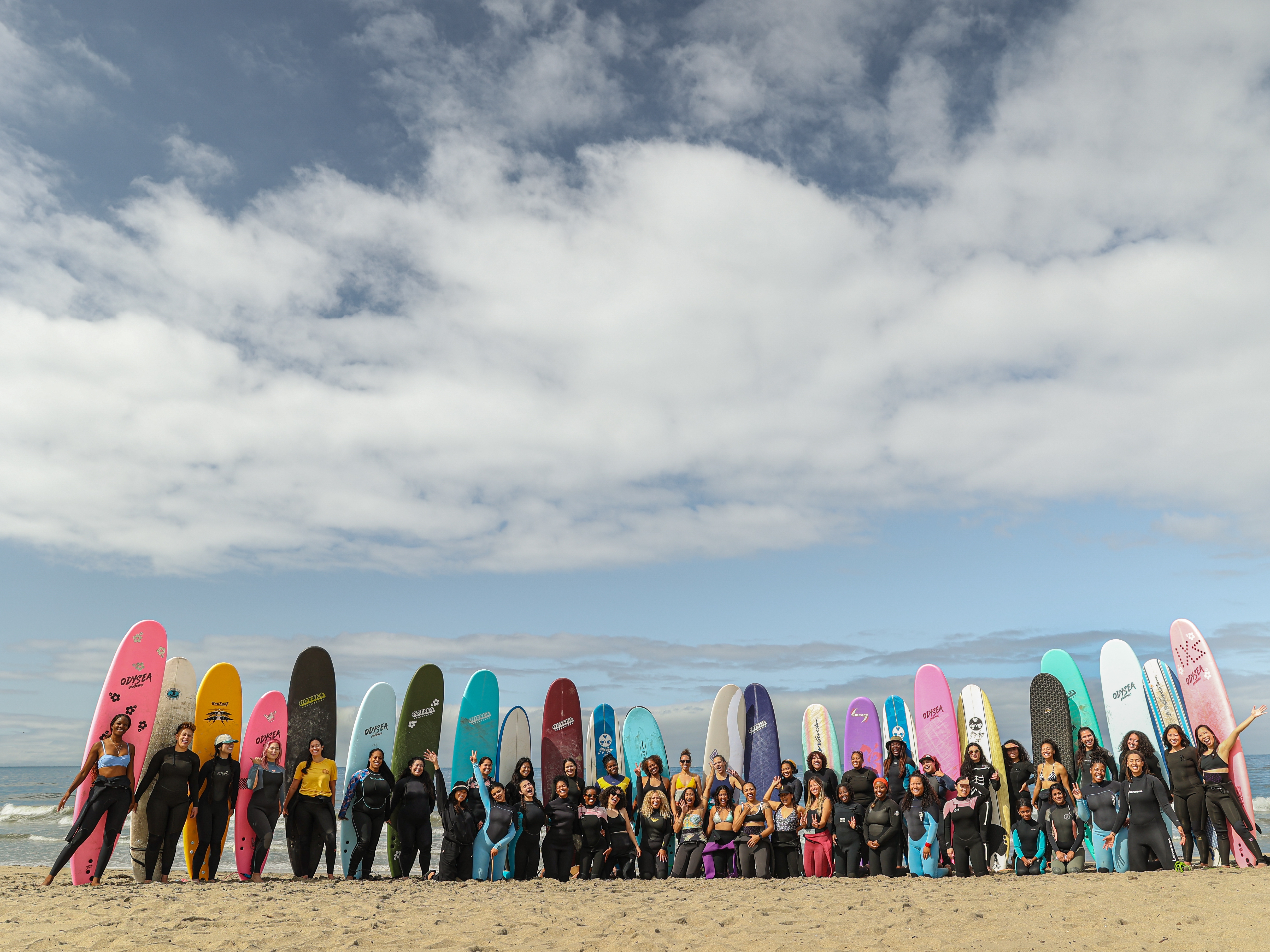 caption: An effort called One More Hour, created by the Foundation for Social Connection and the dating app Hinge, invests in groups where people can find friends — like this surfing club for women of color in Los Angeles called Intrsxtn Surf.