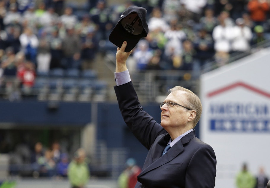caption: Seattle Seahawks owner Paul Allen tips his cap to fans as he is honored for his 20 years of team ownership before an NFL football game against the San Francisco 49ers, Sunday, Sept. 17, 2017, in Seattle.