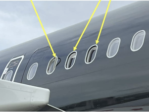 caption: A photo included in the U.K.'s Air Accidents Investigations Branch special bulletin shows the location of one damaged and two missing window panes on an Airbus A321.