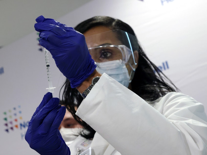 caption: A medical worker at South Shore University Hospital gets ready to administer the newly available Johnson & Johnson COVID-19 vaccine in Bay Shore, N.Y., Wednesday. Clinical research found it to be 85% effective in preventing severe disease four weeks after vaccination, and it has demonstrated promising indications of protection against a couple of concerning variants of the coronavirus.