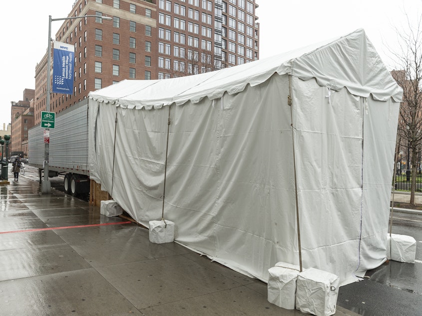 caption: In Manhattan, a makeshift morgue is set up next to Lenox Health Greenwich Village.