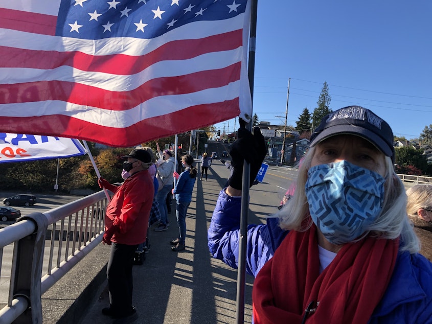 caption: An Anti-Trump group waved flags over I-5 in Seattle on Nov. 8, 2020.