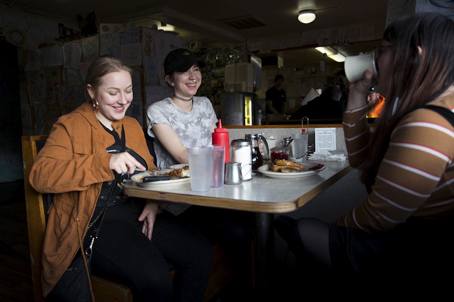 caption: From left, Haley Shay'e, Lexi Rasmussen and Bee Shields eat breakfast on Monday, March 11, 2019, at Beth's Cafe in Seattle.