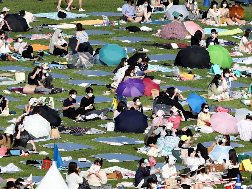 caption: Festivalgoers attend a music festival at Olympic Park on June 26, 2021 in Seoul, South Korea.