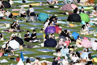 caption: Festivalgoers attend a music festival at Olympic Park on June 26, 2021 in Seoul, South Korea.