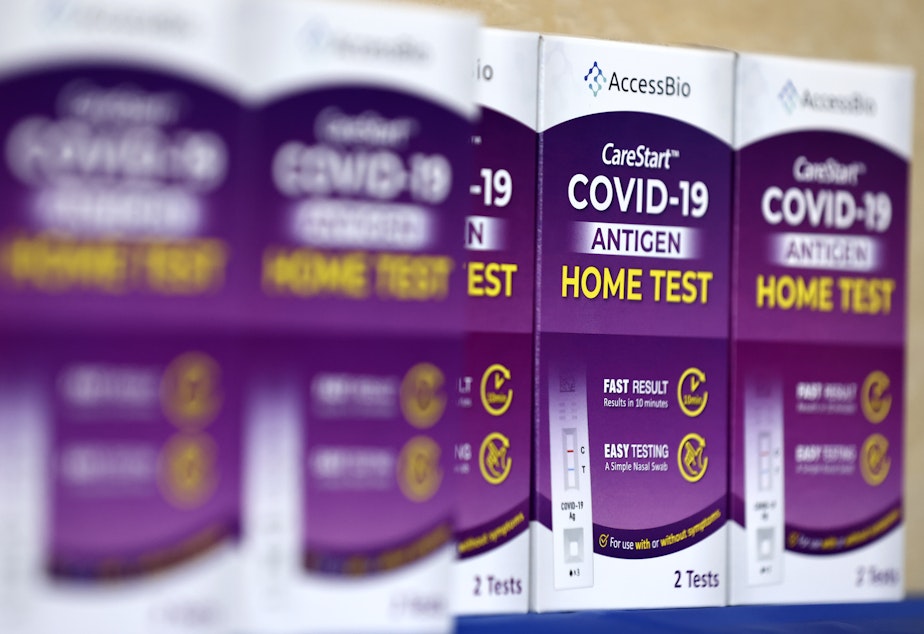 caption: COVID-19 at-home rapid test kits are seen in Los Angeles on Jan. 7.