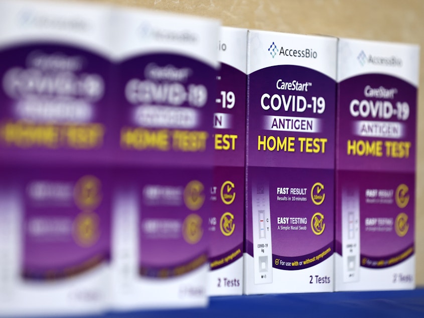 caption: COVID-19 at-home rapid test kits are seen in Los Angeles on Jan. 7.