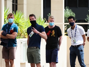 caption: People associated with the Australian Open are seen lining up at a testing facility at the View Hotel on Thursday in Melbourne, Australia. Victoria state has reintroduced COVID-19 restrictions after a hotel quarantine worker tested positive for the coronavirus on Wednesday.