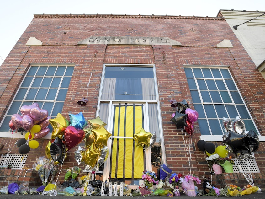 caption: A makeshift memorial is created at the scene of the fatal shooting at a dance studio in Dadeville, Ala. Two teenagers have been arrested and charged with murder in connection with the shooting that killed four young people at a Sweet Sixteen birthday party, investigators announced Wednesday.