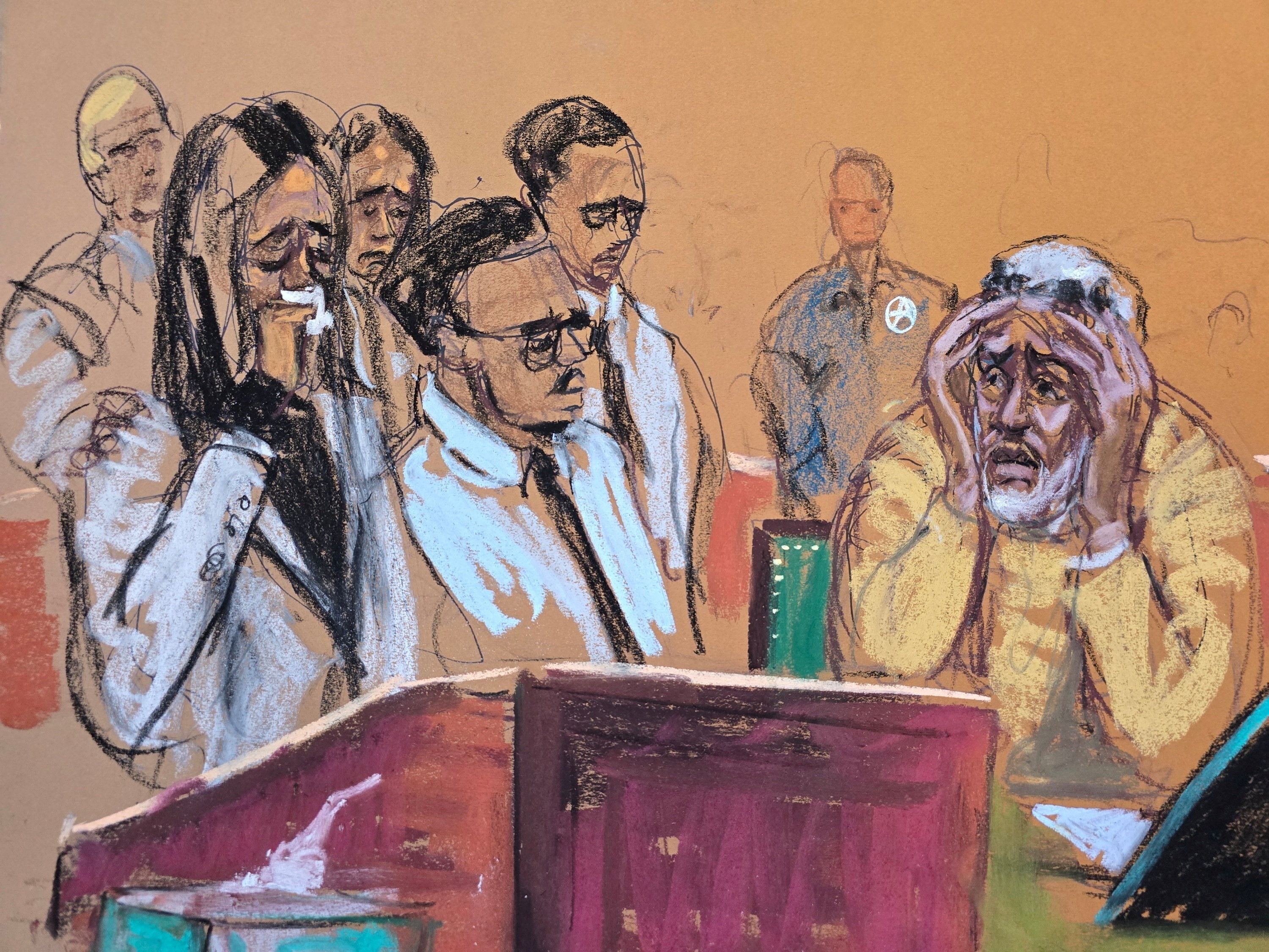 caption: Sean Combs (at right) watches his children present impact statements during his sentencing hearing in New York. Combs was sentenced to 50 months in prison.