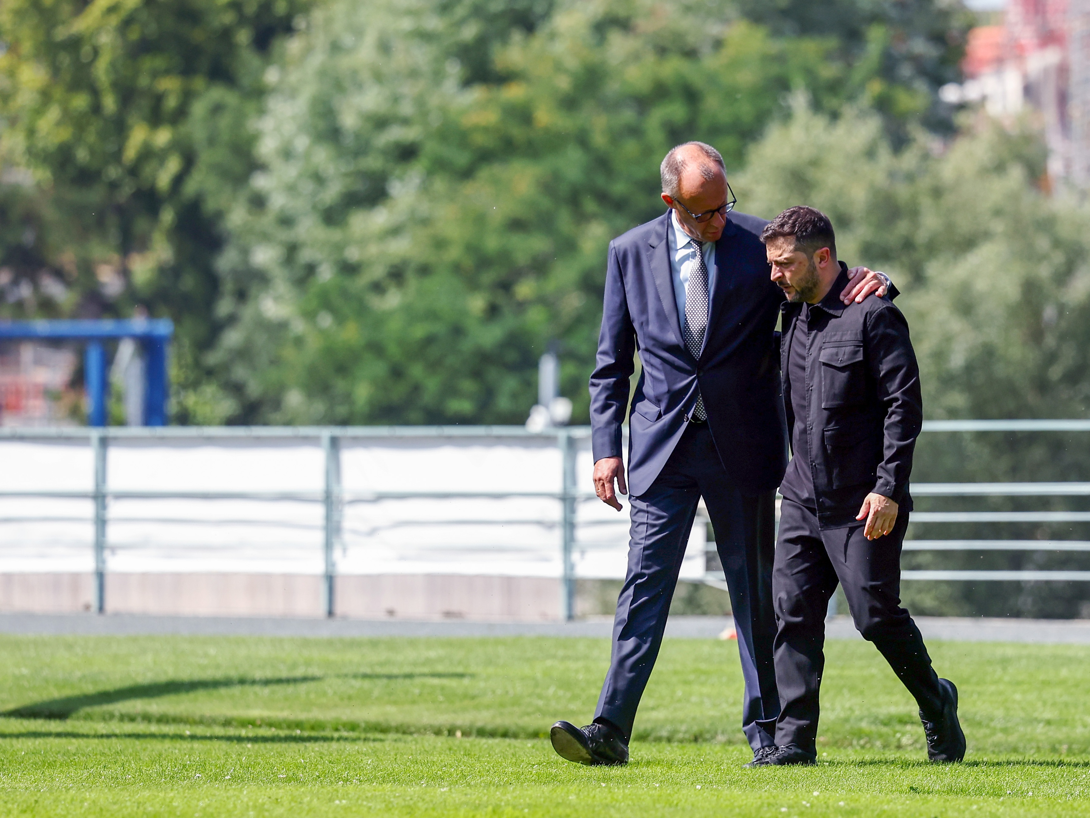 caption: German Chancellor Friedrich Merz (left) welcomes Ukrainian President Volodymyr Zelenskyy in Berlin on Aug. 13.