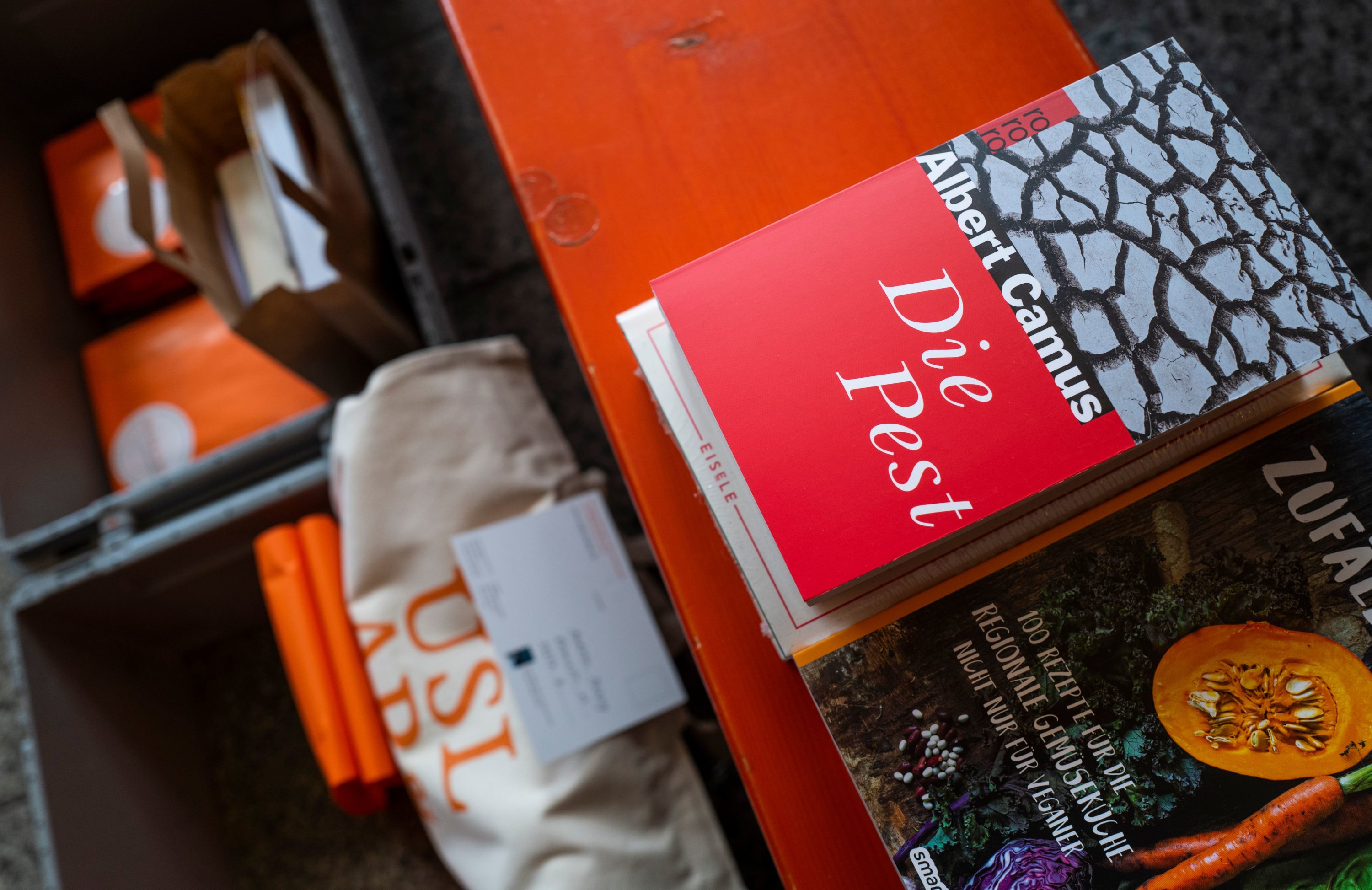 caption: French writer Albert Camus's book "The Plague" (Die Pest, La Peste) is put out for delivery at the Uslar & Rai Bookshop in Berlin's Prenzlauer Berg district on March 31, 2020, amid a new coronavirus COVID-19 pandemic. (JOHN MACDOUGALL/AFP via Getty Images)