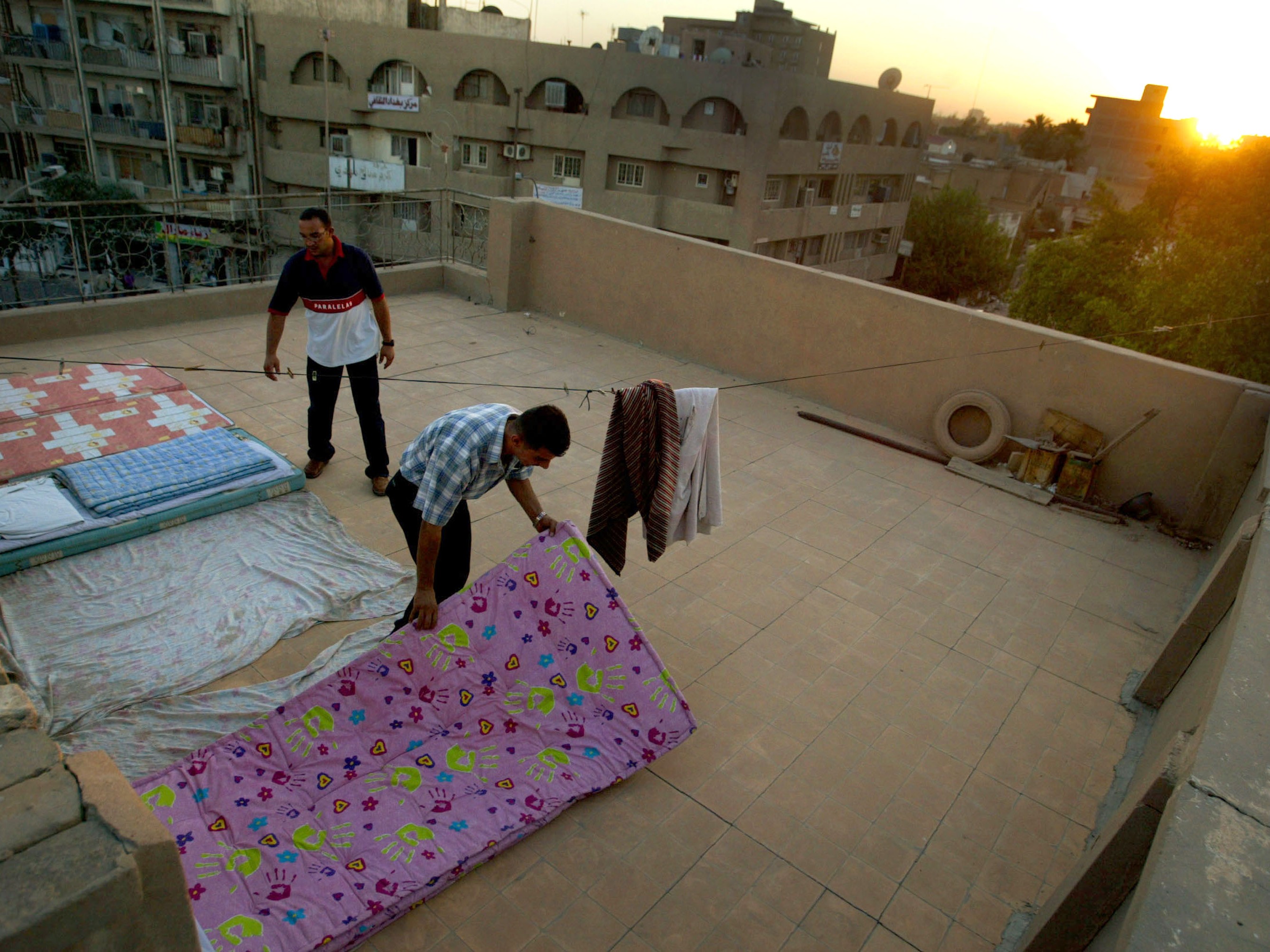 caption: Heat makes it harder to sleep. In Baghdad, some neighbors set up mattresses on their roof to find a cool sleeping spot. A new study finds the risk of sleep apnea goes up along with temperatures.