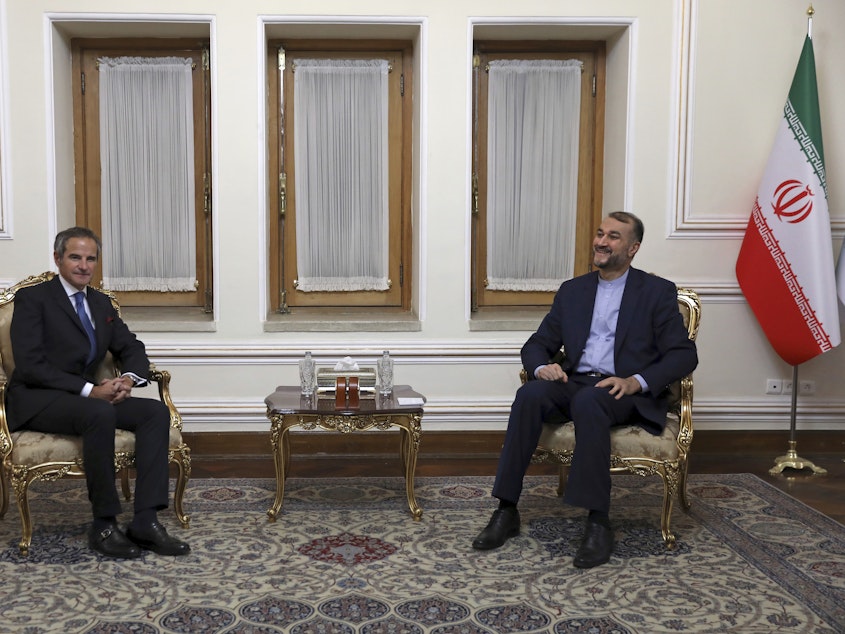caption: Head of the International Atomic Energy Agency Rafael Mariano Grossi, left, and Iranian Foreign Minister Hossein Amirabdollahian pictured meeting in Tehran, on Tuesday. Grossi pressed for greater access in the Islamic Republic ahead of diplomatic talks restarting over Tehran's tattered nuclear deal with world powers.