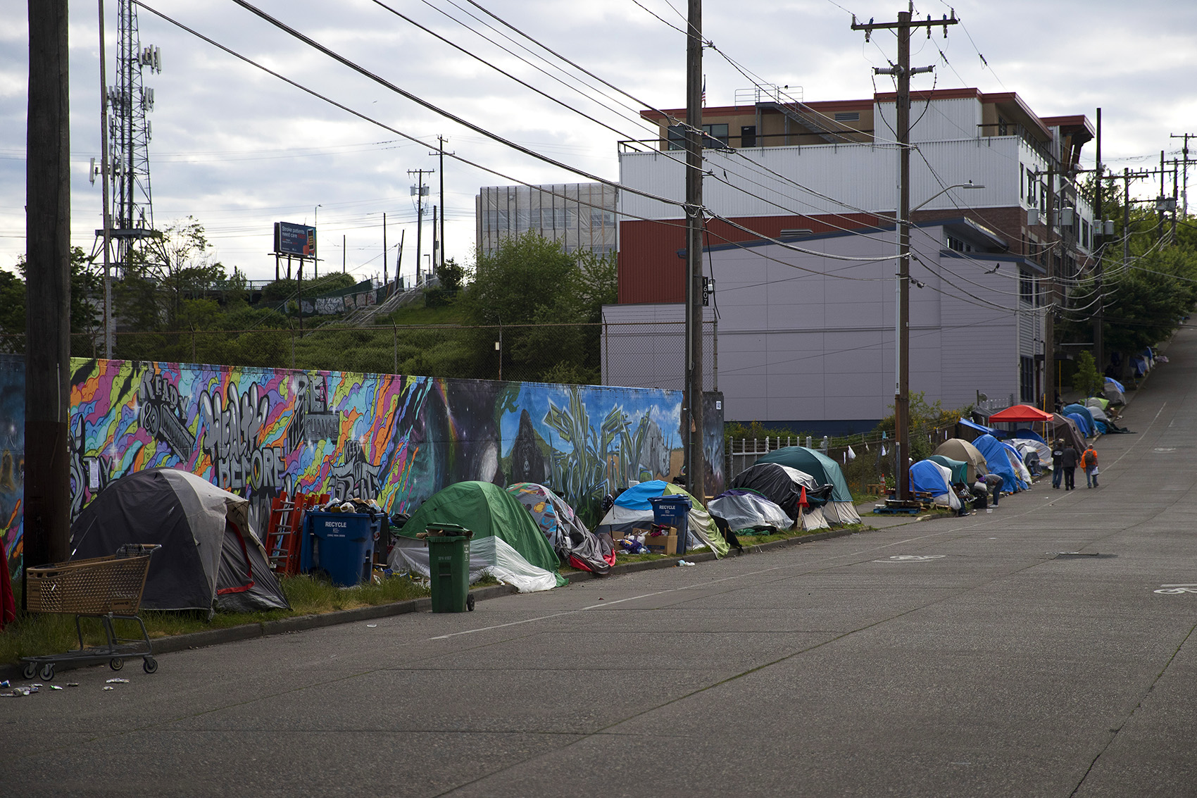 caption: In this file photo, tents line South Weller Street near the intersection of 12th Avenue South on Tuesday, May 19, 2020, in Seattle.