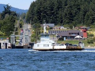 caption: Ferry systems serving San Juan, Skagit, and Whatcom counties are looking for funding options to solve service challenges; over-budget bids have temporarily stalled the planned all-electric replacement of the aging ferry between Anacortes and Guemes Island.