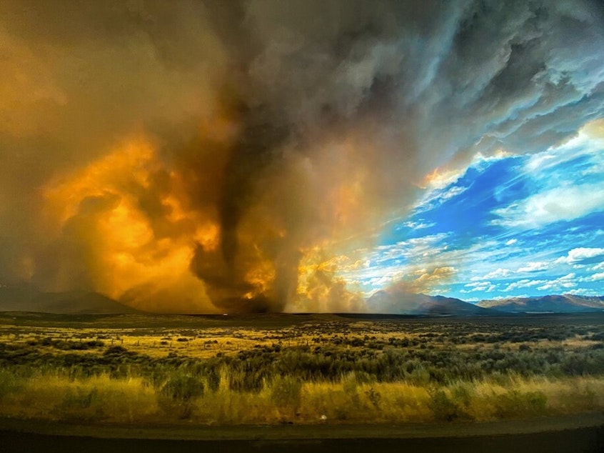 caption: A funnel appears in a thick plume of smoke from the Loyalton Fire in Lassen County, Calif., Saturday, Aug. 15, 2020.