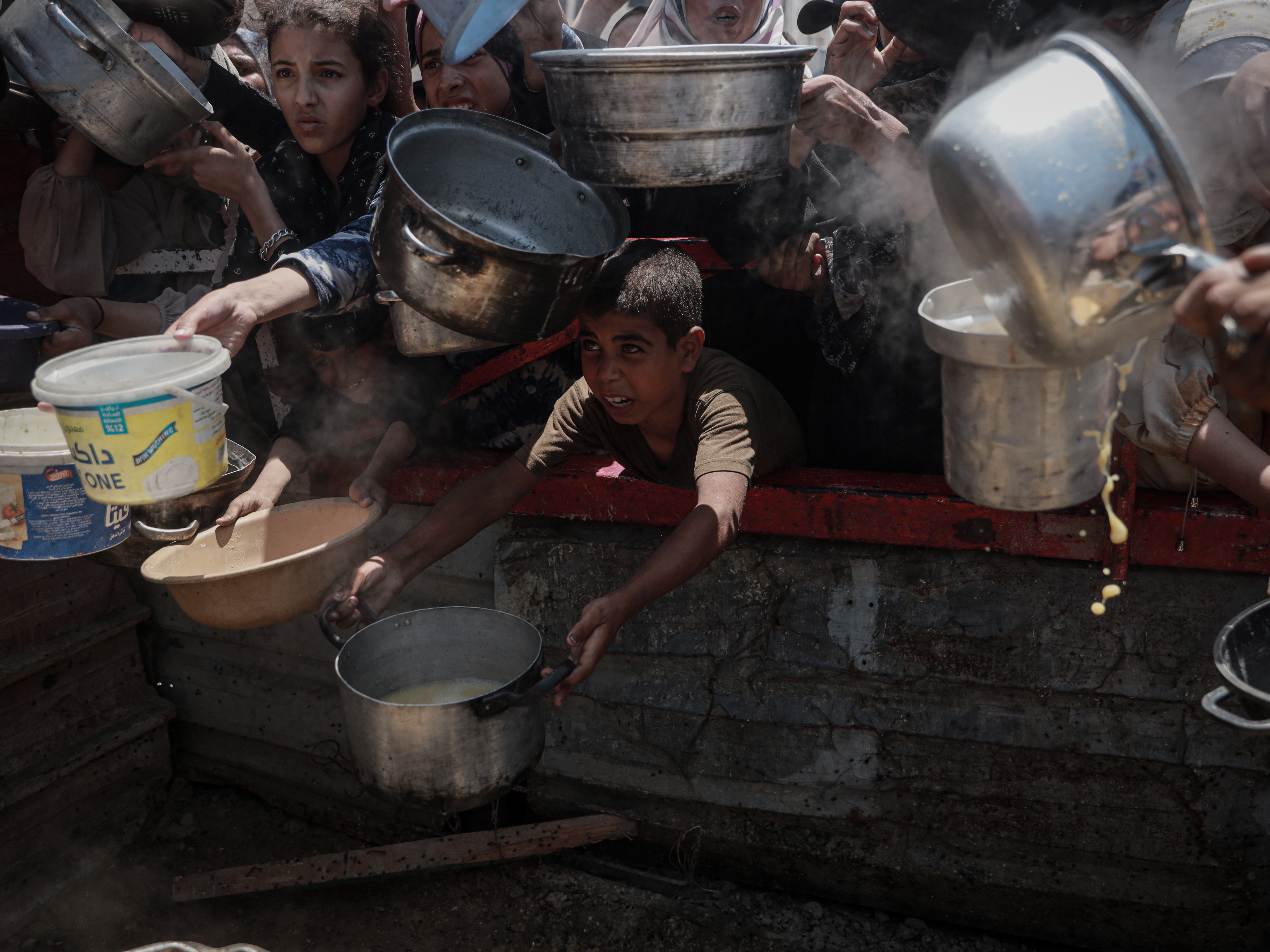 caption: Hundreds of Palestinians wait for hours to receive food aid in Gaza City on July 27.