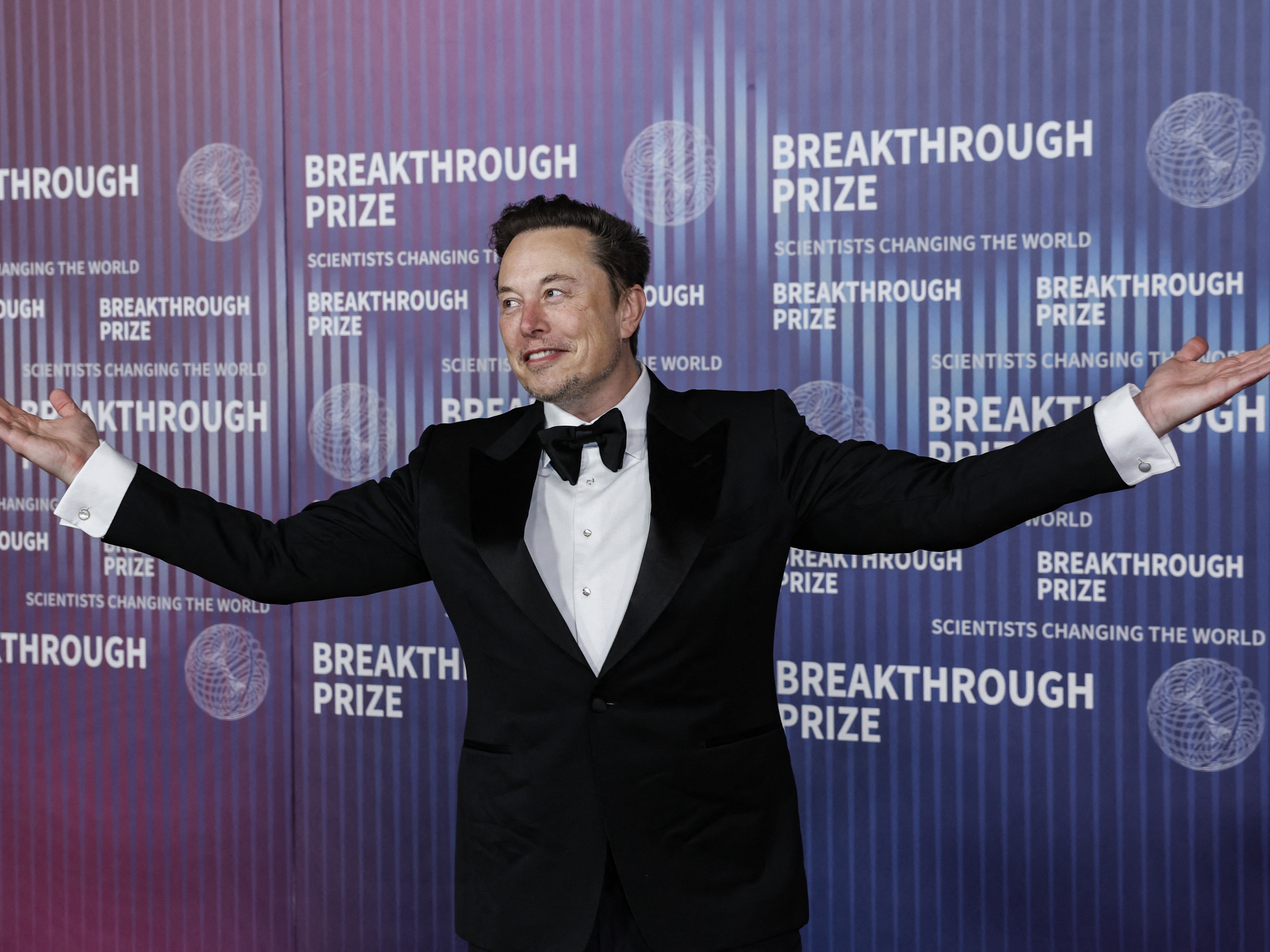 caption: Tesla CEO Elon Musk gestures at the Tenth Breakthrough Prize Ceremony at the Academy Museum of Motion Pictures in Los Angeles, California, on April 13, 2024. Tesla is hosting an event it's calling "We, Robot" in Hollywood on Thursday night.