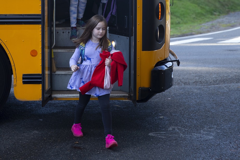 caption: Lily Butler, 7, arrives home from school on Wednesday, Nov. 22, 2023, in Kenmore, Washington.