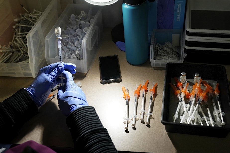 caption: A registered nurse fills syringes with Pfizer vaccines at a Covid-19 vaccination clinic at PeaceHealth St. Joseph Medical Center Thursday, June 3, 2021, in Bellingham, Wash.