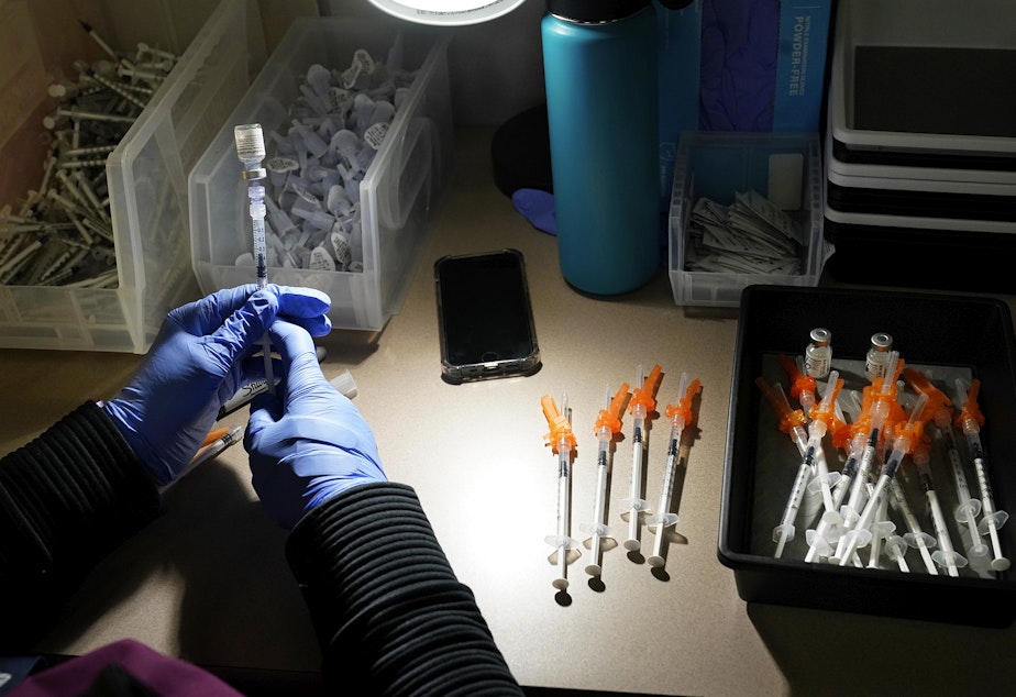 caption: A registered nurse fills syringes with Pfizer vaccines at a Covid-19 vaccination clinic at PeaceHealth St. Joseph Medical Center Thursday, June 3, 2021, in Bellingham, Wash. 