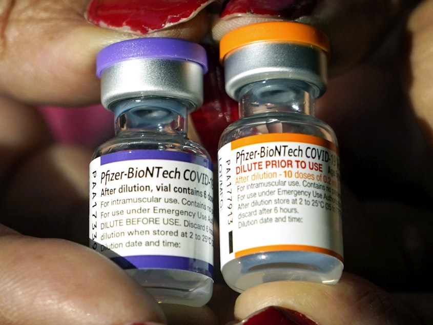 caption: A nurse holds a vial of the Pfizer COVID-19 vaccine for children ages 5 to 11, right, and a vial of the vaccine for adults, which has a different colored label, at a vaccination station in Jackson, Miss. on Feb. 8, 2022.