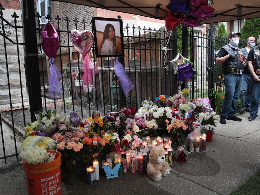 caption: Candles burn in front of a memorial for 10-year-old Lena Nunez on June 29, 2020 in Chicago. Nunez was shot and killed by a stray bullet while watching television with her brother in her grandmother's Logan Square home. Nunez was one of at least 17 people who died from gun violence in the city that weekend.