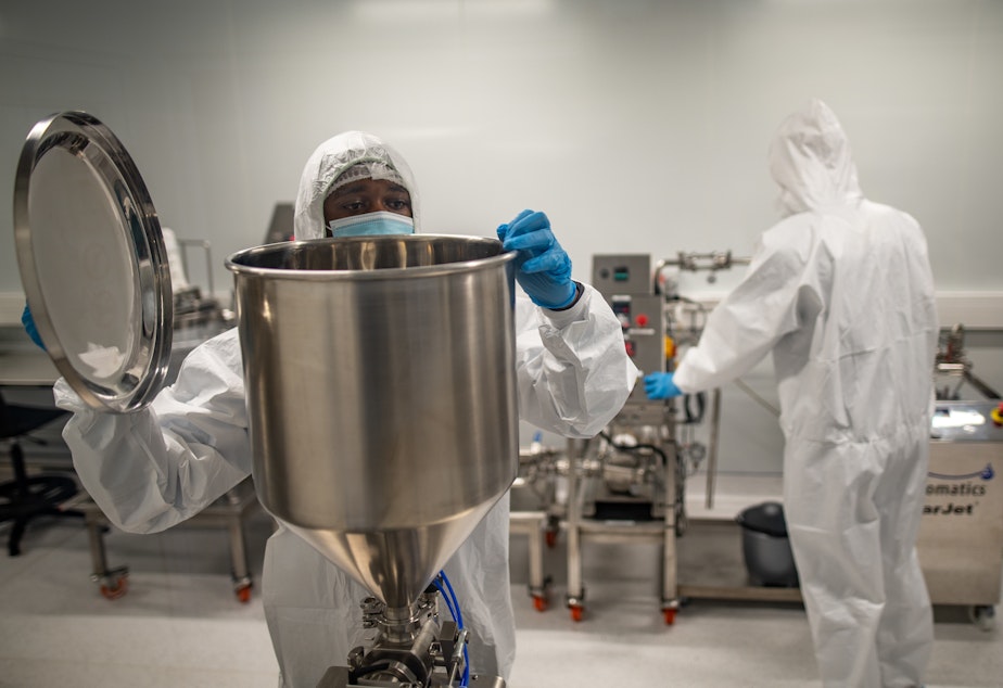 caption: Members of a team at the Afrigen Biologics and Vaccines lab in Cape Town, South Africa. The World Health Organization has enlisted the company to replicate Moderna's COVID-19 vaccine.