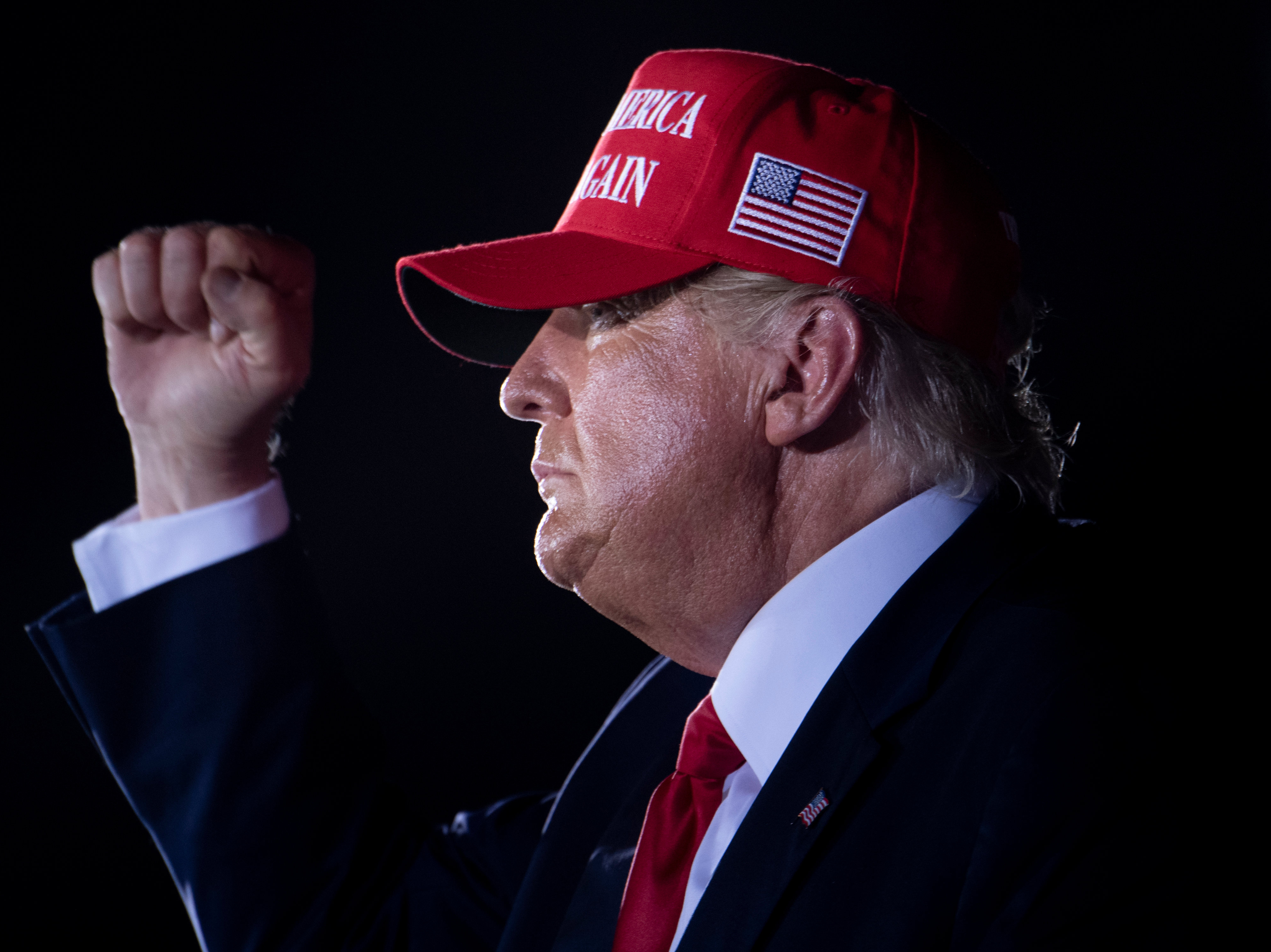 caption: After Trump supporters chanted "Fire Fauci!" at a late-night campaign rally, President Trump responded, "Don't tell anybody, but let me wait until a little bit after the election." Trump is seen here leaving the event at Miami-Opa Locka Executive Airport in Opa Locka, Fla., in the early hours of Monday.