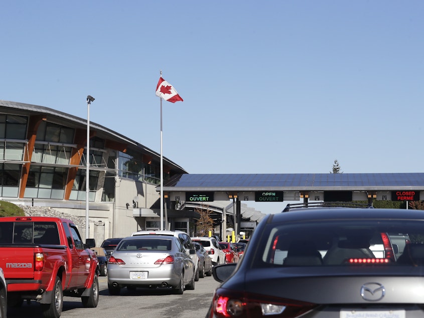 caption: Traffic enters Canada from the United States at the Peace Arch Border Crossing in Blaine, Wash., in 2019. Vaccinated Americans will be able to travel to Canada, starting Aug. 9.