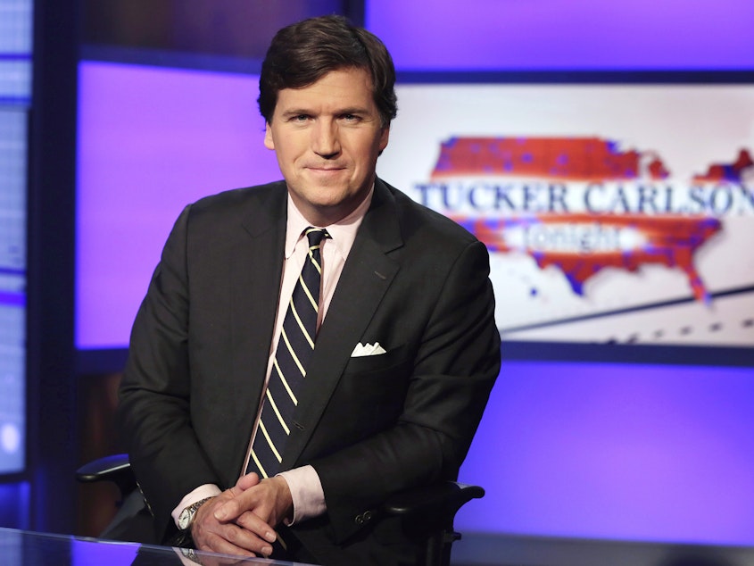 caption: Tucker Carlson, host of "Tucker Carlson Tonight," poses for photos in a Fox News Channel studio, in New York.