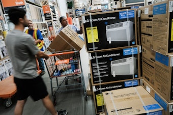 caption: People shop for air conditioners during a heat wave last week in New York City. Many people who live in public housing can't afford such units or the utility bills that come with them — and there's no federal requirement for air conditioning.