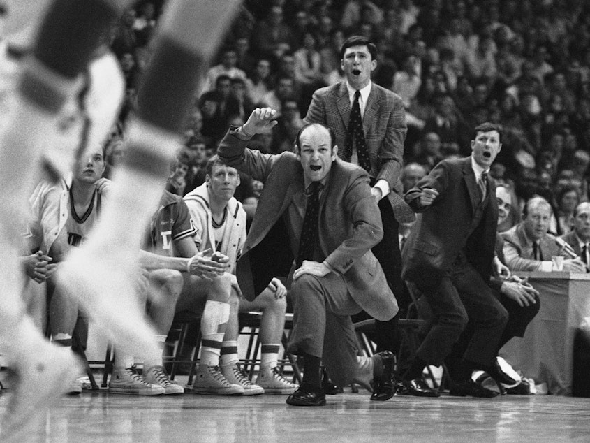 caption: Davidson head coach Lefty Driesell drops to a knee in front of his bench as he watches North Carolina win an NCAA Eastern Regional basketball tournament at College Park, Md., on March 15, 1969. Driesell, the coach whose folksy drawl belied a fiery on-court demeanor that put Maryland on the college basketball map, died Saturday.