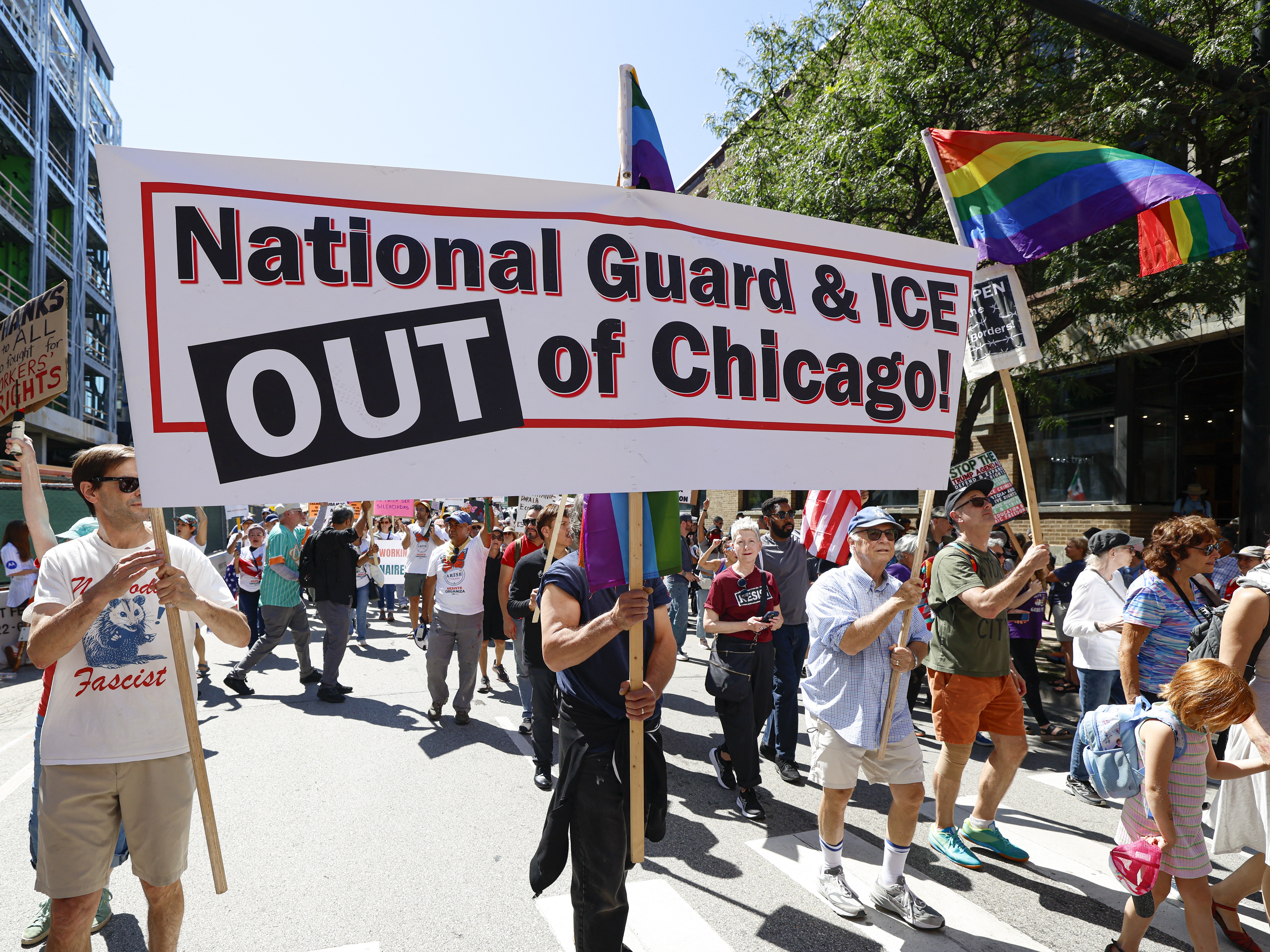 caption: Marchers at a Labor Day rally in Chicago protested President Trump's threatened National Guard deployment on Monday.