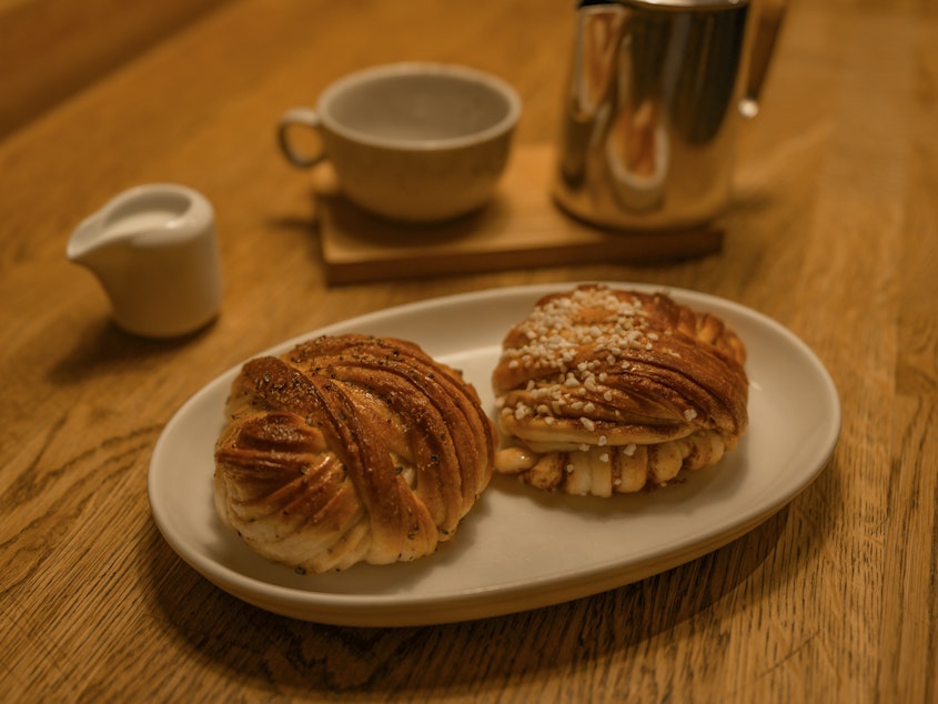 caption: Cinnamon and cardamon bun served in a Swedish cafe, often eaten at <em>fika </em>– a Swedish word that's often translated as "coffee and cake break." <em></em>
