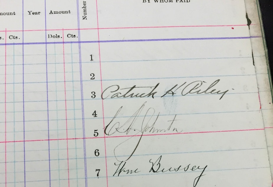 caption: Patrick Riley's (top) signature on the tax ledgers that homeowners would sign every year.