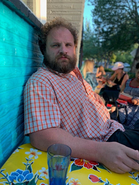 caption: Sam Miller is a stand-up comedian. In his set, he talks about his experiences with drug and alcohol addiction, incarceration and homelessness. Offstage, he works with teenagers struggling with those same issues.