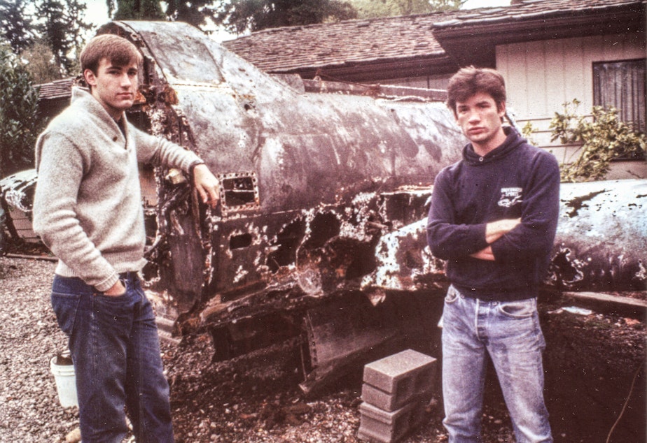 caption: Jeff Hummel (left) and Matt McCauley (right) posing with the remains of a dredged plane.
