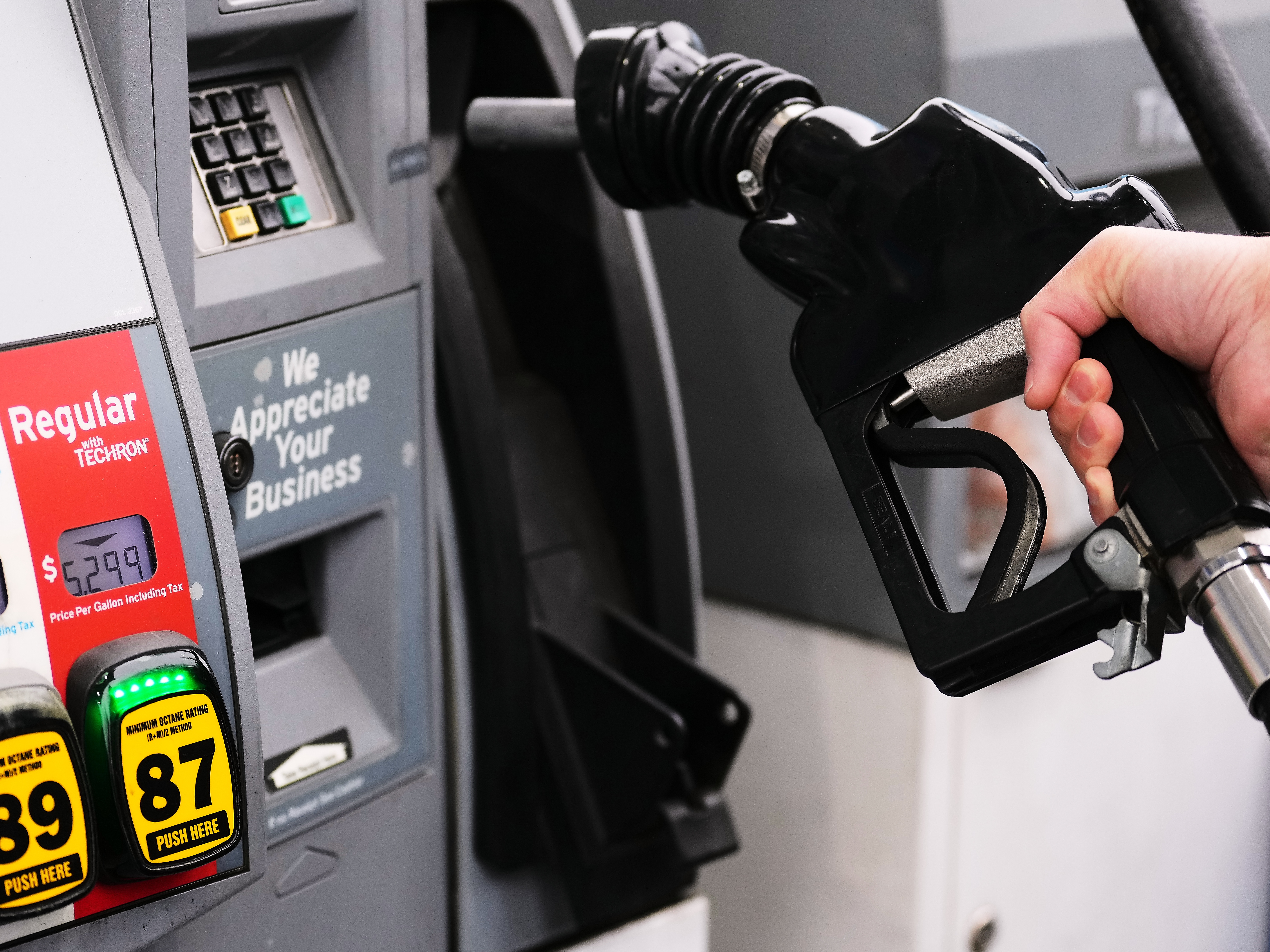 caption: A customer fuels up with regular gasoline priced at $5.29 at a Chevron gas station in Bellevue, Wash., Friday, March 13, 2026.