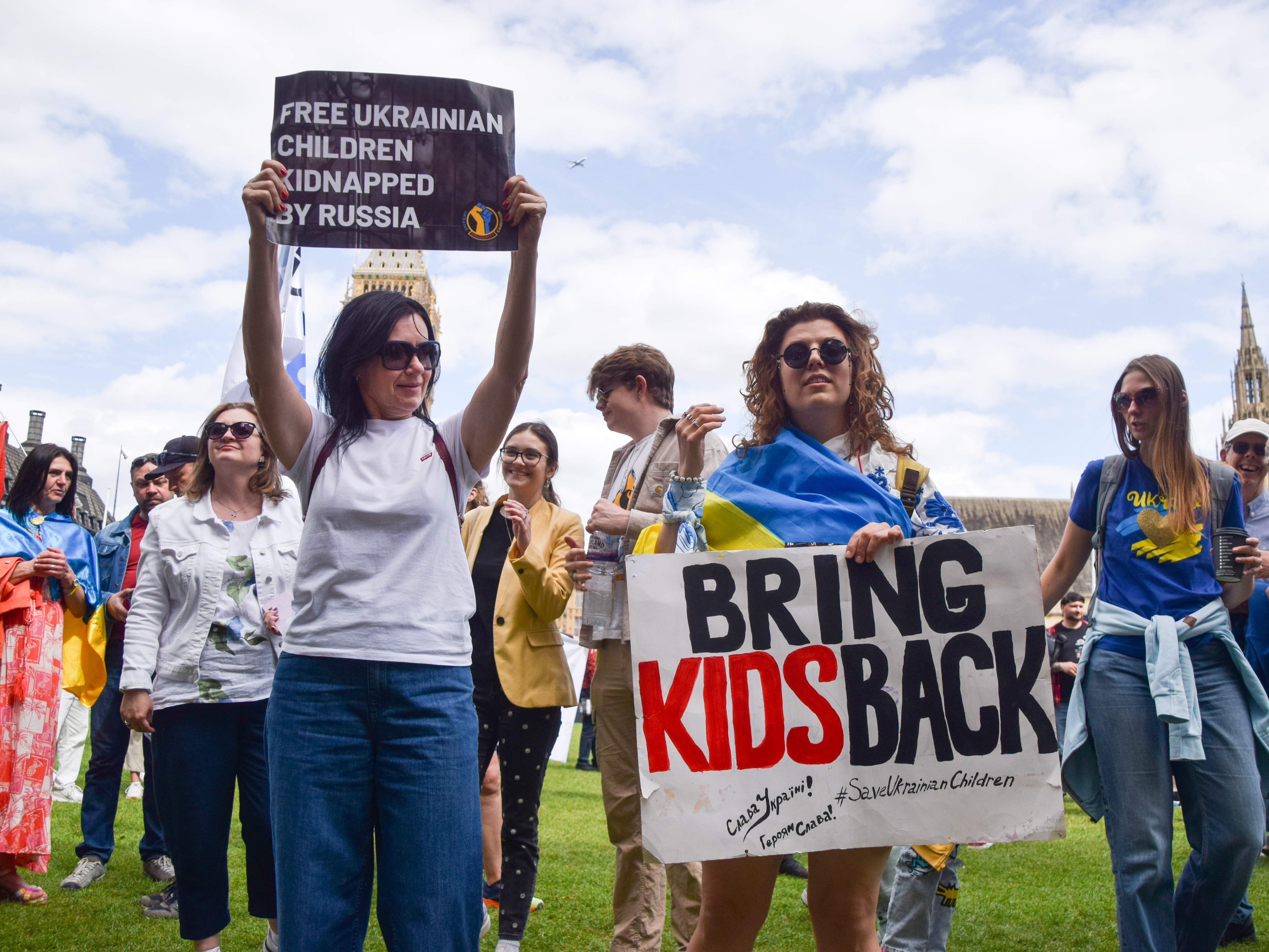 caption: Protesters hold placards during a demonstration in Parliament Square in London, demanding the release of Ukrainian children kidnapped by Russia and an end to Russian aggression in Ukraine. The Ukrainian government has insisted that the return of children from Russia be part of any peace deal with the country.