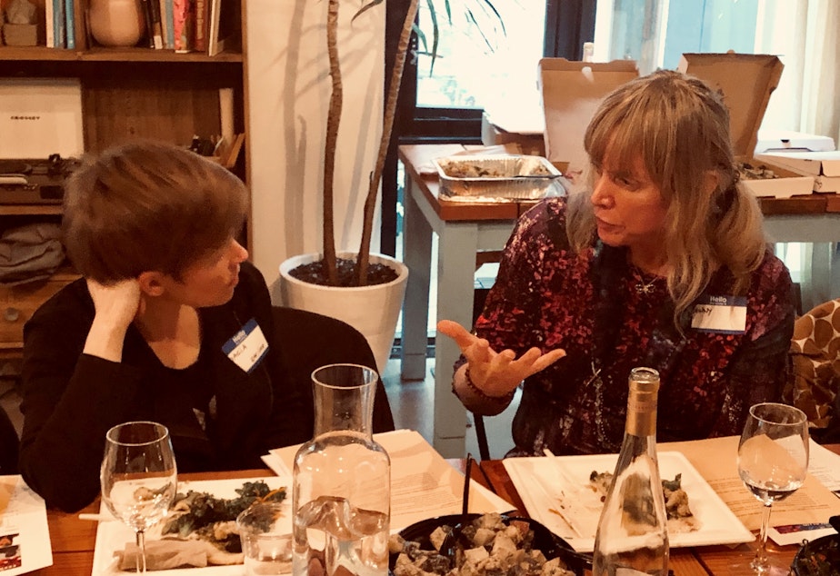 caption: Queeriosity Club members Dacia Clay (left) and Jennifer Hegeman  talk during KUOW's first Pride-themed Curiosity Club dinner at The Cloud Room in Seattle. June 7, 2019. 